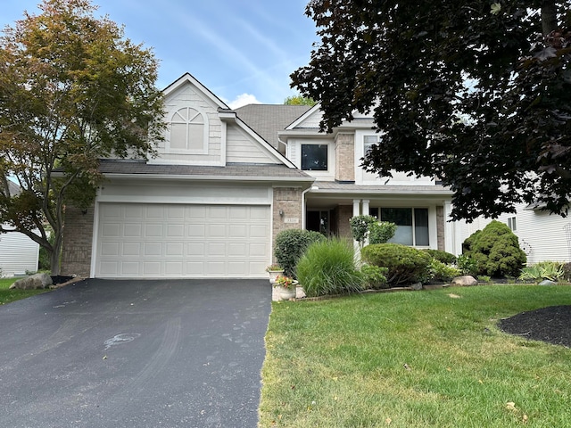 view of front of home with a front yard and a garage