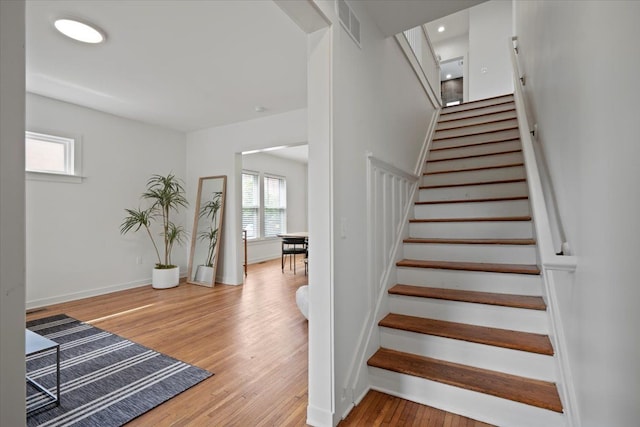 staircase with hardwood / wood-style flooring