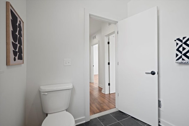 bathroom with toilet and wood-type flooring