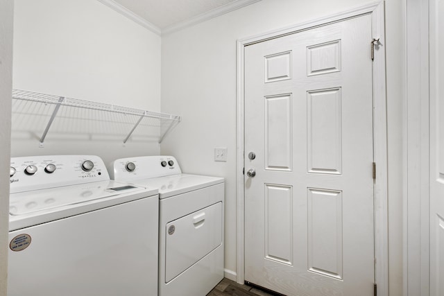 laundry area featuring washer and clothes dryer, dark hardwood / wood-style flooring, and crown molding