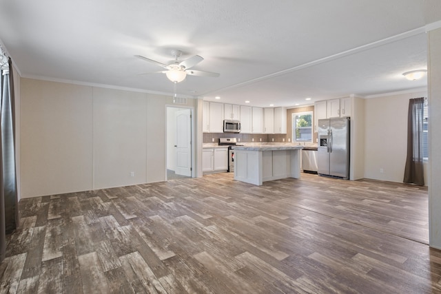 kitchen with a kitchen island, light wood-type flooring, white cabinetry, and stainless steel appliances