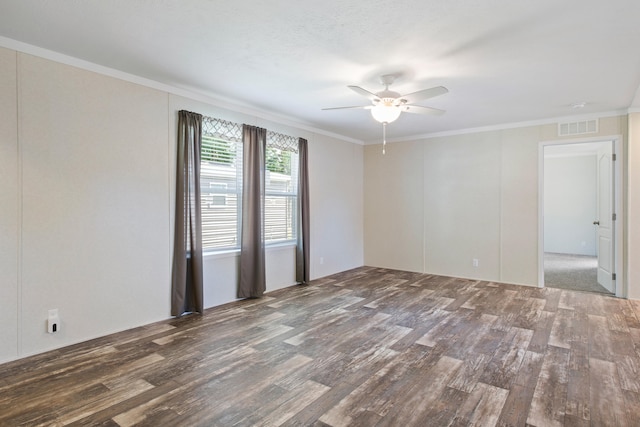 spare room featuring dark hardwood / wood-style floors, ceiling fan, and ornamental molding