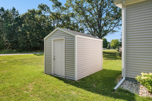 view of outdoor structure with a lawn