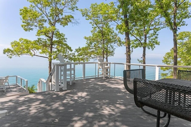 view of dock with a deck with water view