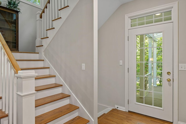 interior space featuring lofted ceiling and hardwood / wood-style flooring