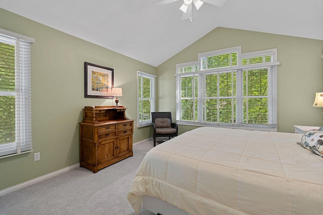 carpeted bedroom with ceiling fan, lofted ceiling, and multiple windows