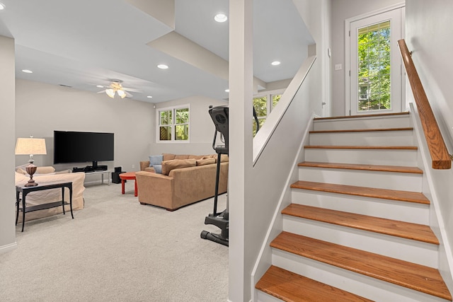 staircase featuring carpet and ceiling fan