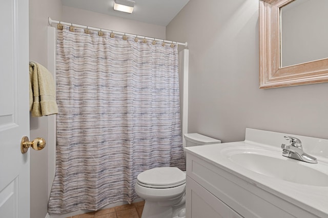 bathroom featuring tile patterned floors, curtained shower, vanity, and toilet