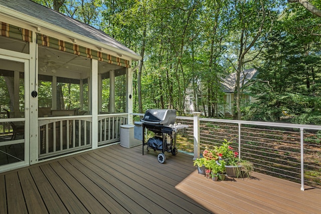 wooden terrace featuring area for grilling and a sunroom