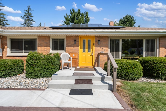 ranch-style house with solar panels