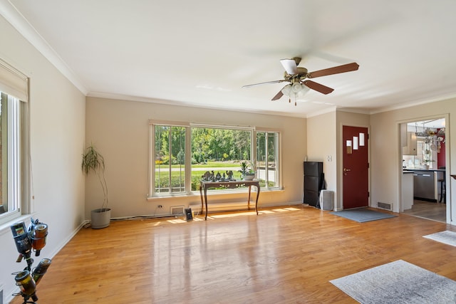 interior space featuring light hardwood / wood-style flooring, ceiling fan, and crown molding