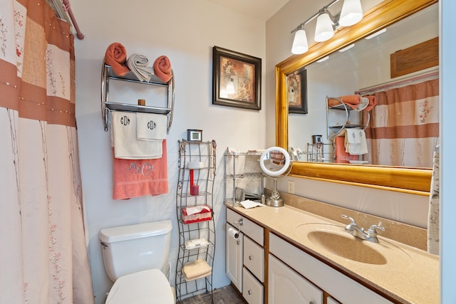 bathroom with walk in shower, vanity, and toilet