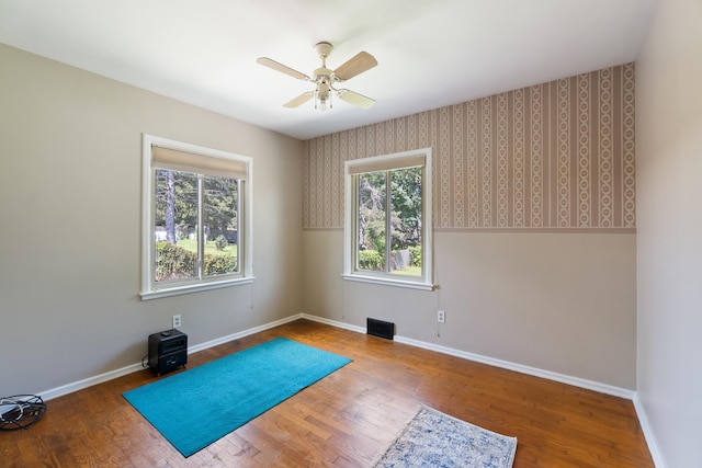 exercise room with ceiling fan and hardwood / wood-style flooring