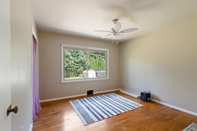 unfurnished room featuring ceiling fan and hardwood / wood-style flooring