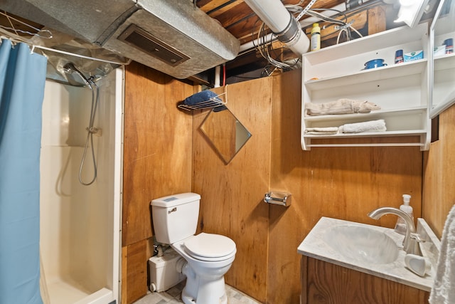 bathroom featuring wood walls, toilet, vanity, and a shower with shower curtain