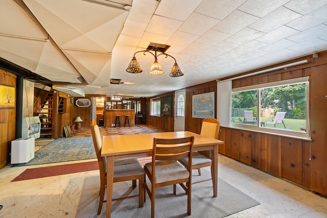 dining area featuring wood walls