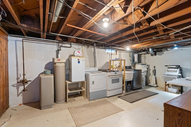 basement featuring washing machine and dryer, electric panel, and sink