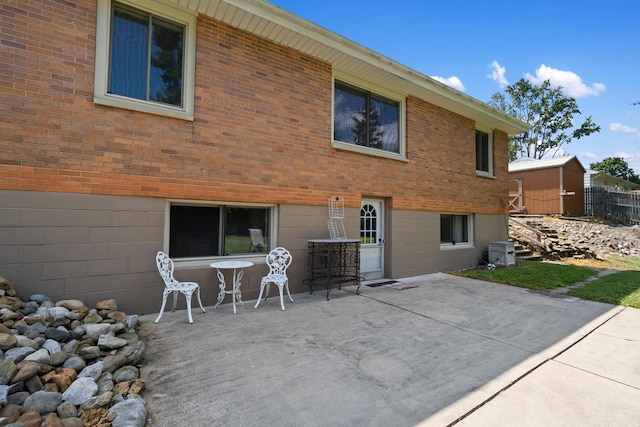 rear view of house featuring central AC and a patio