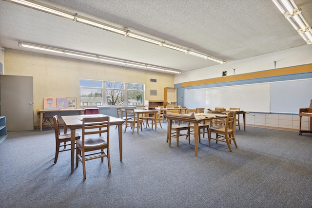 carpeted dining space featuring a textured ceiling