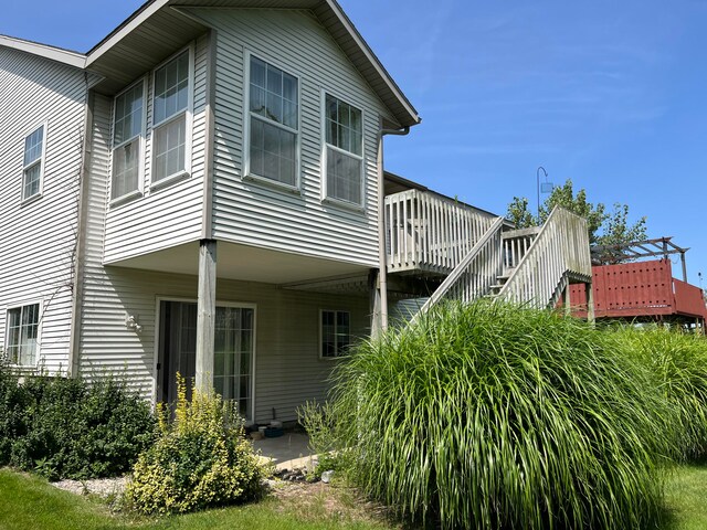 rear view of property with stairway