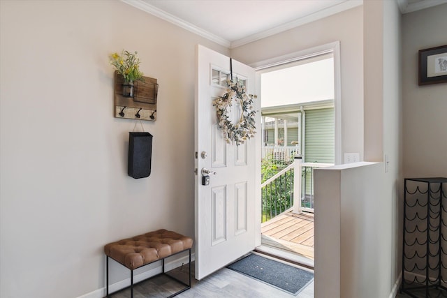 entryway featuring light wood-type flooring and crown molding