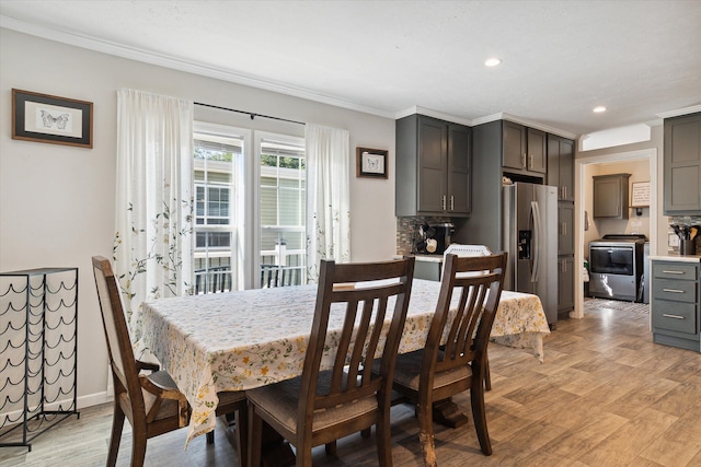 dining space with light hardwood / wood-style flooring and crown molding