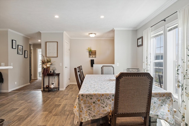 dining room with wood-type flooring, crown molding, and a healthy amount of sunlight