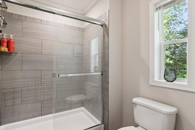 bathroom featuring toilet, an enclosed shower, and crown molding