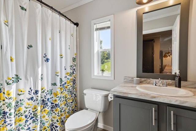 bathroom with toilet, vanity, a shower with shower curtain, and ornamental molding