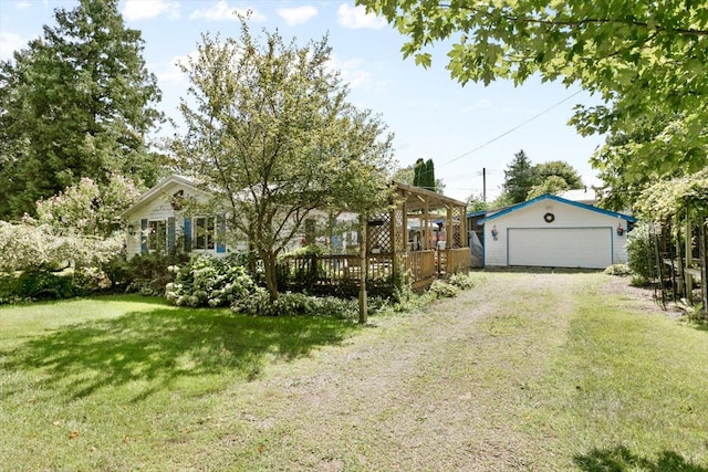 view of front of house with an outbuilding, a garage, a front lawn, and a wooden deck