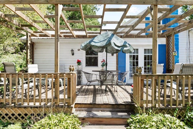 wooden deck featuring a pergola and french doors