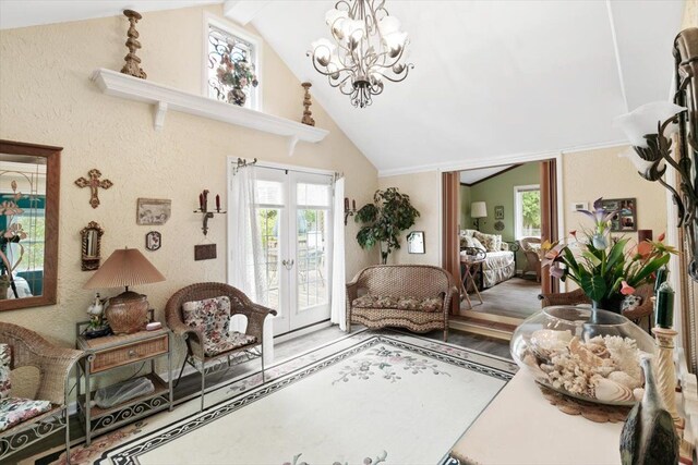 7400 Aspen Rd, Lexington, MI 48450 - living area featuring a chandelier, plenty of natural light, wood finished floors, and high vaulted ceiling
