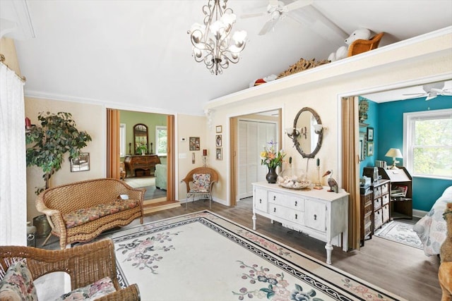 foyer entrance with a notable chandelier, vaulted ceiling with beams, and dark hardwood / wood-style floors