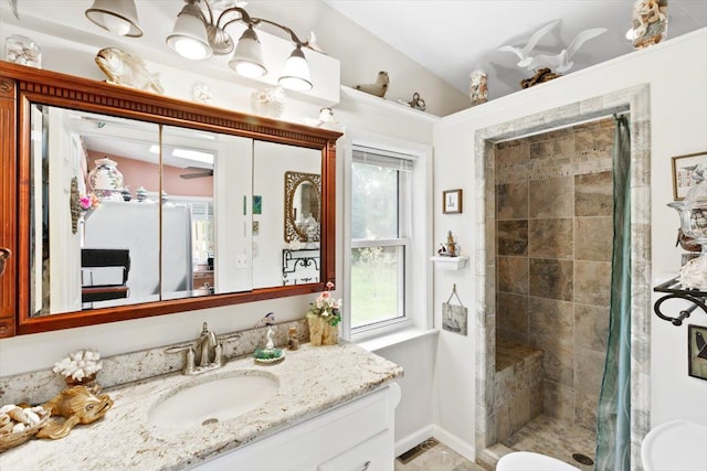 bathroom featuring a shower with shower curtain and vanity