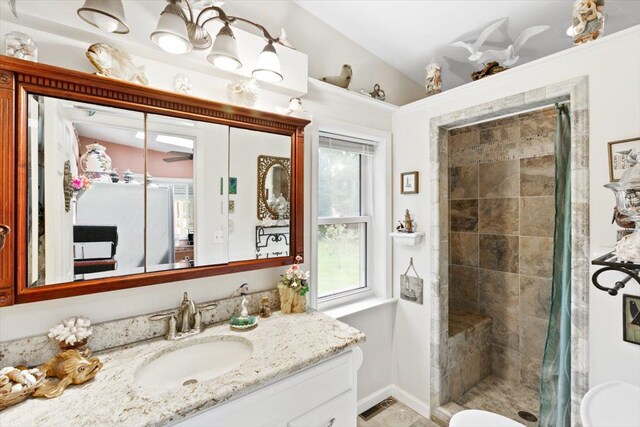 7400 Aspen Rd, Lexington, MI 48450 - bathroom with vanity, tiled shower, and baseboards