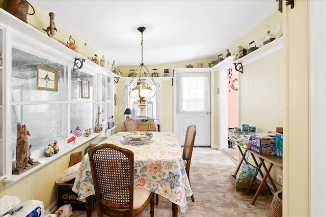 dining space featuring vaulted ceiling and an inviting chandelier