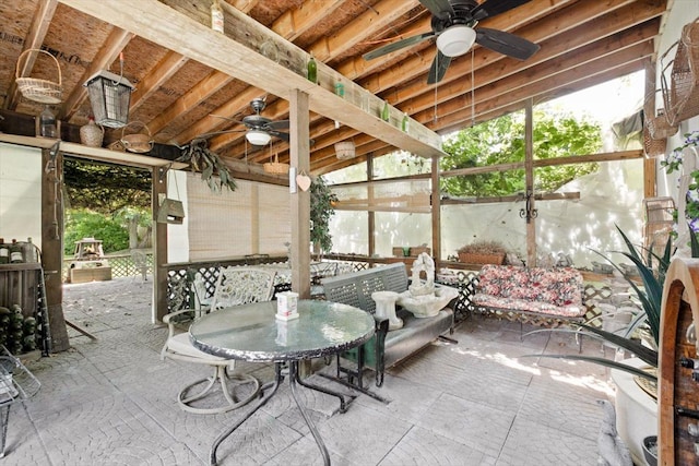 sunroom / solarium featuring ceiling fan and vaulted ceiling