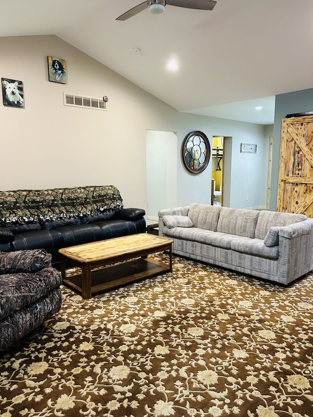 carpeted living room with ceiling fan and lofted ceiling