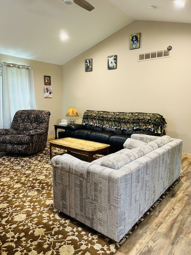 living room featuring lofted ceiling, ceiling fan, and dark hardwood / wood-style floors