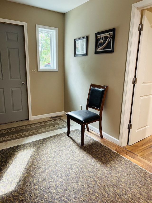 sitting room with wood-type flooring