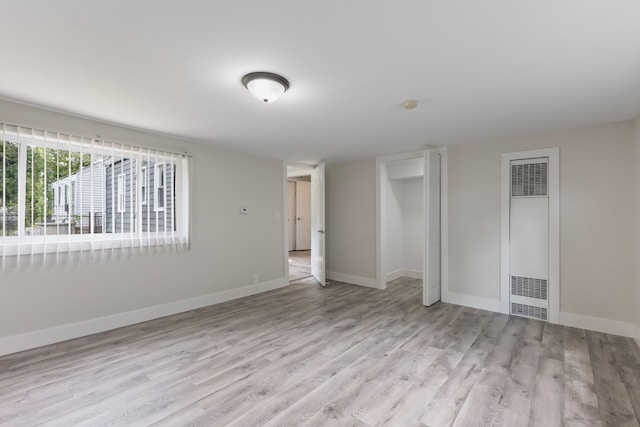 empty room with light hardwood / wood-style flooring