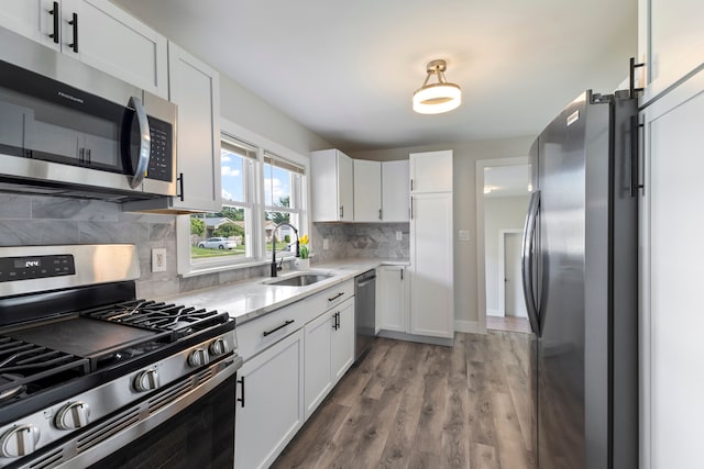 kitchen featuring white cabinets, backsplash, sink, and stainless steel appliances