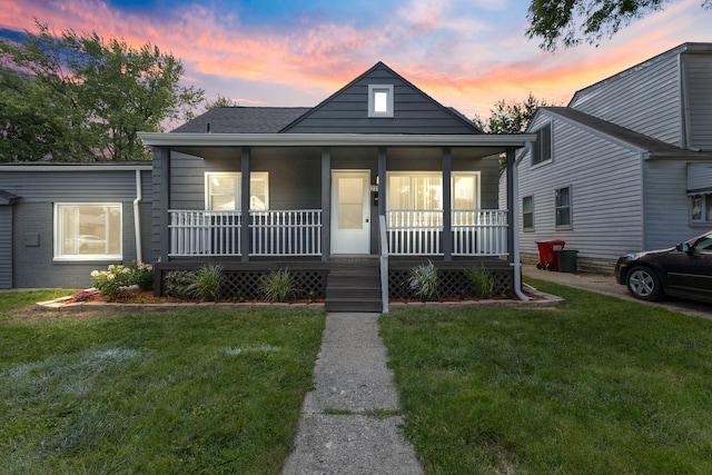 bungalow-style home with a yard and a porch