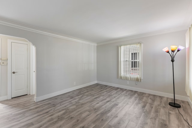 empty room with light hardwood / wood-style flooring and ornamental molding