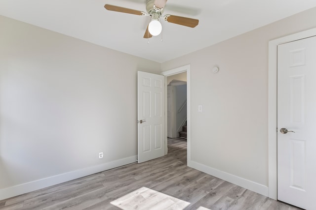 unfurnished bedroom with ceiling fan and light hardwood / wood-style floors