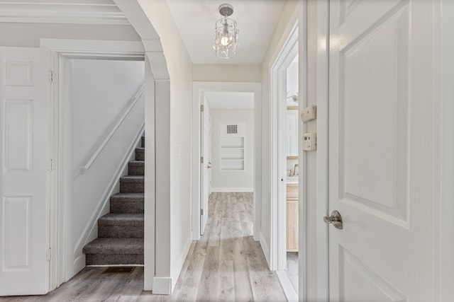 interior space with light wood-type flooring and an inviting chandelier