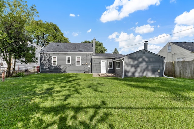 rear view of house with a lawn