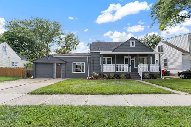 view of front facade with covered porch, a garage, and a front yard