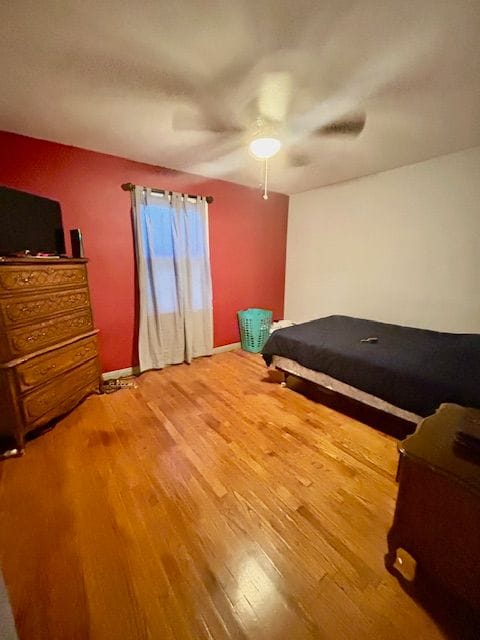 bedroom featuring ceiling fan and hardwood / wood-style floors