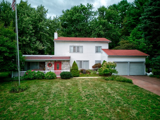 view of front of house with a front yard and a garage